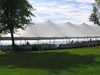 Tent with White Plastic Chairs At Lake